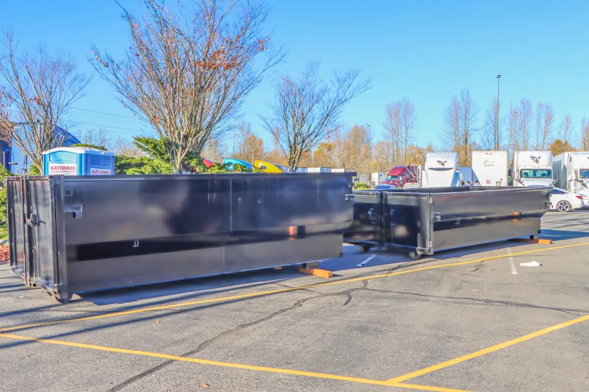 Professional dumpster rental service with roll-off container on residential driveway in Nebraska City